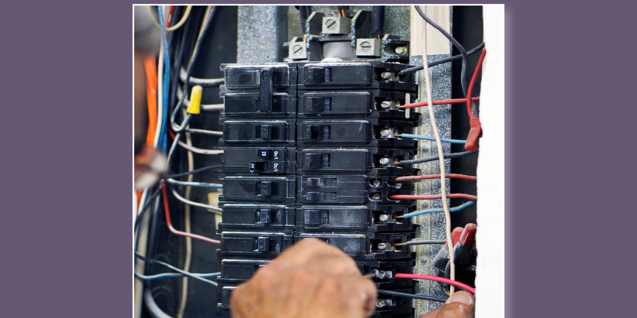 a purple box with a photo of an electrical panel with a persons hands working on it.