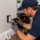 Electrician testing a residential electrical outlet with a multimeter during an electrical troubleshooting service call.